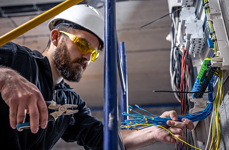 Electrician connecting the power to the control panels.