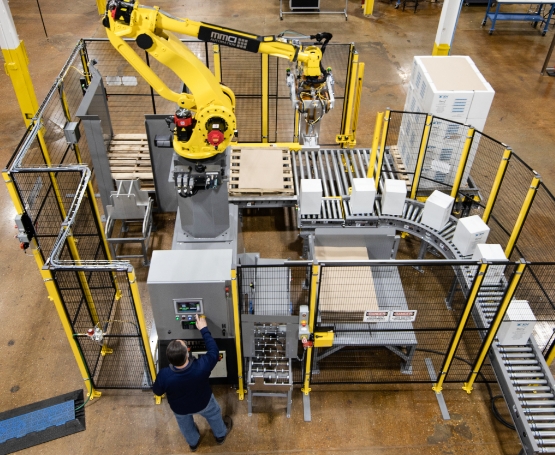 Robot in the Palletizing area placing boxes on to the waiting pallets.