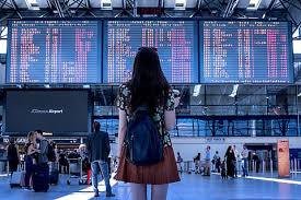 Studying the flights departure board at an International Airport.