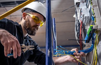 Electrician connecting the power to the control panels.
