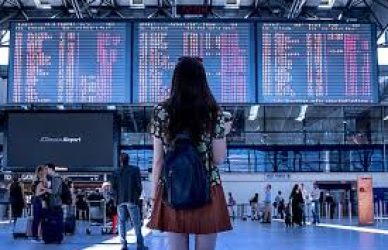 Studying the flights departure board at an International Airport.